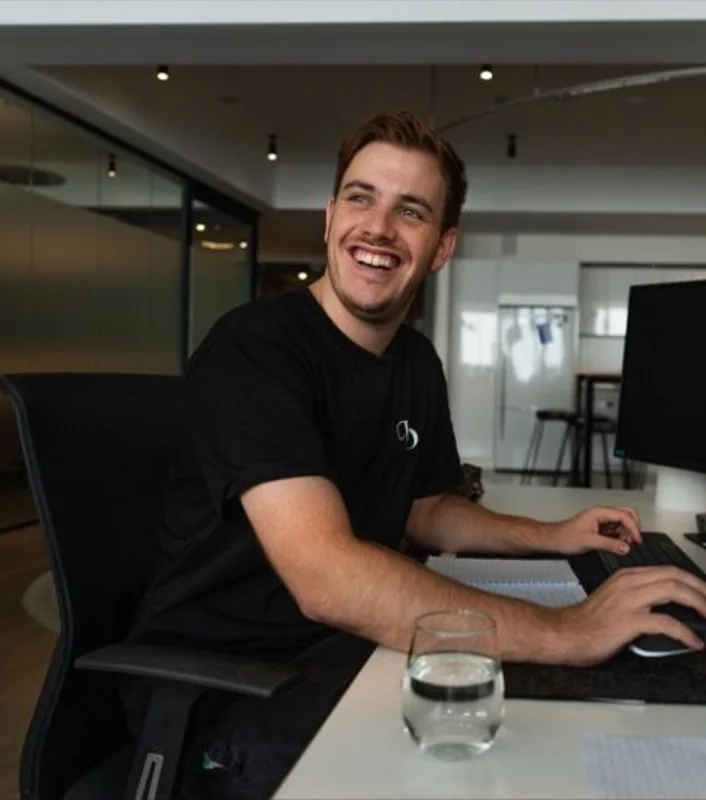 Benji Hugh, performance marketing consultant, working at his desk in Sydney
